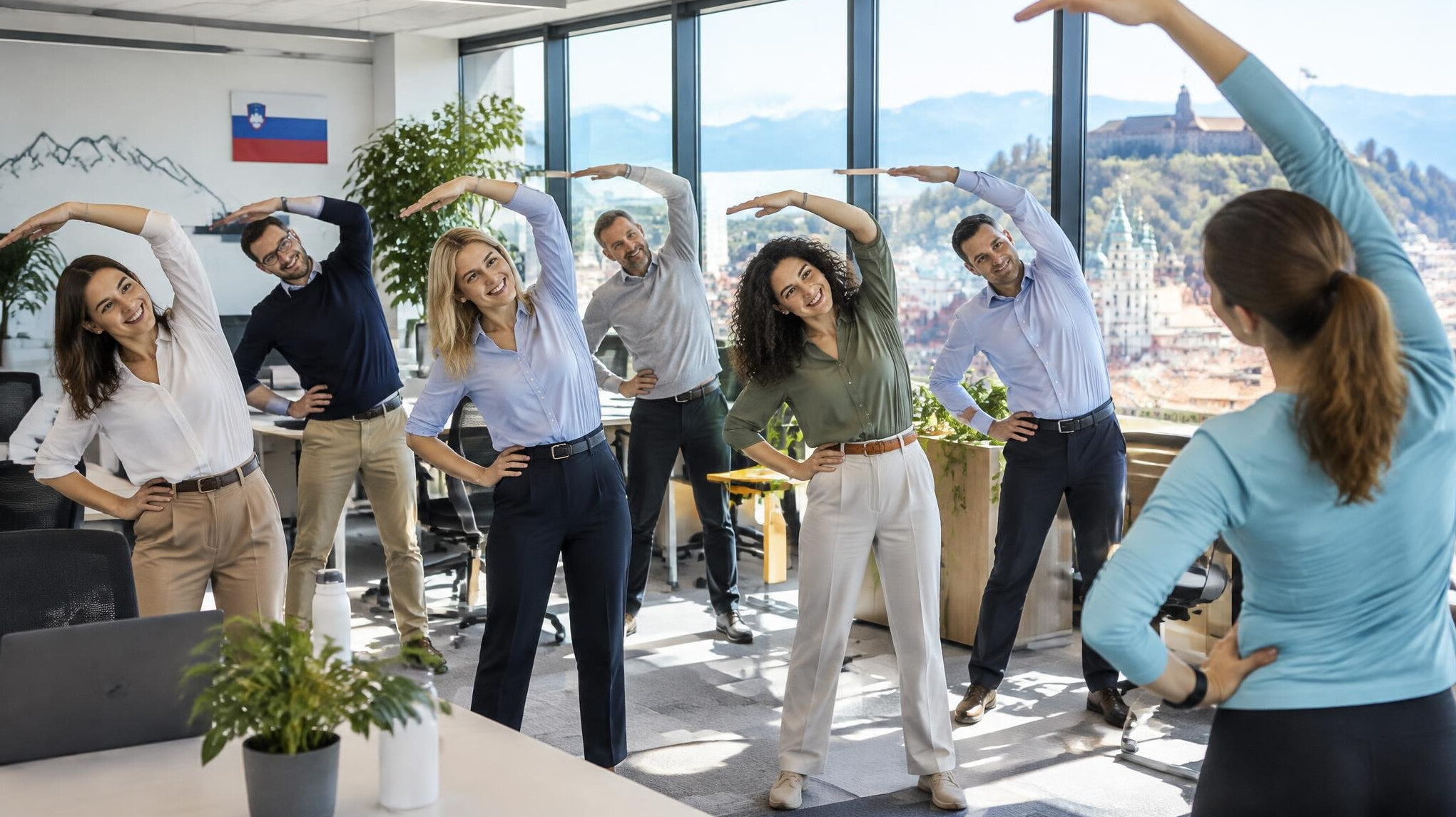 Office workers stretching together during a workplace wellness break